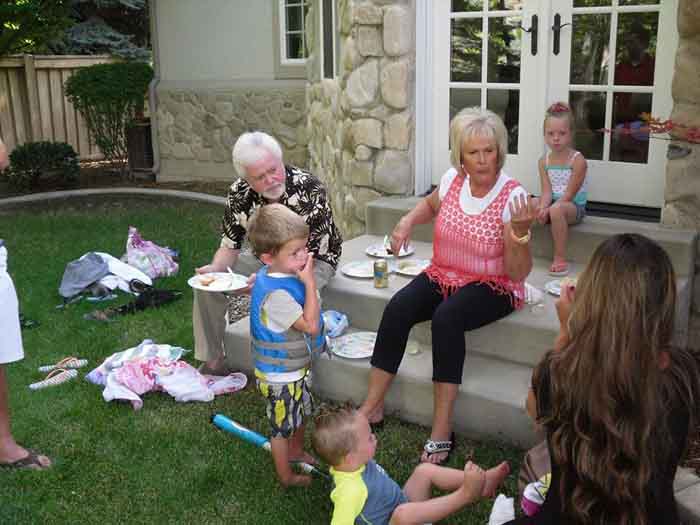Mary Carlson and her husband Merrill Osmond playing with their grand children.